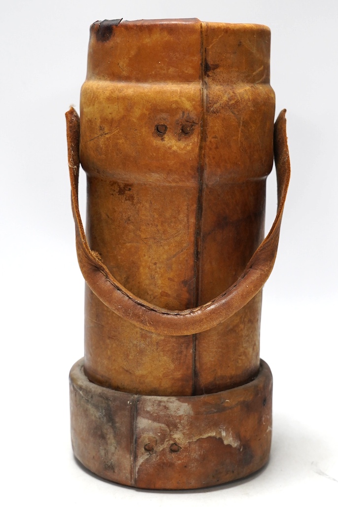 A leather powder flask, with painted Royal crest, 33cm high. Condition - poor to fair, some staining to the leather and wear at the edges